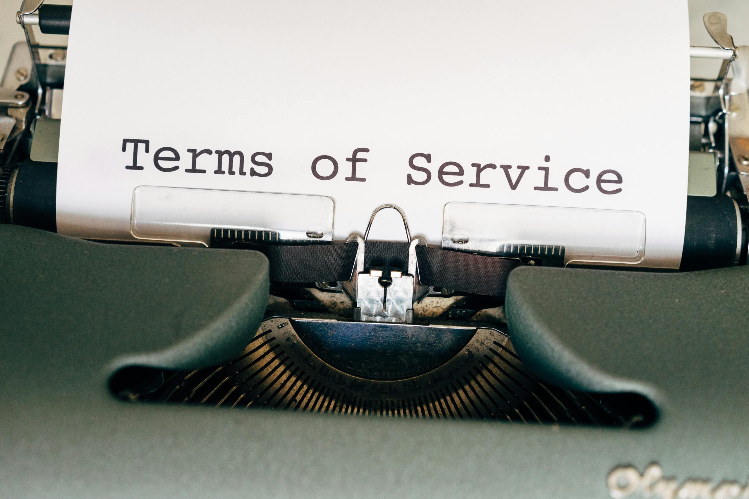 A vintage typewriter with a paper displaying 'Terms of Service'. Perfect for business or legal themes.